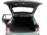 the back of a silver car with its trunk open on a white background