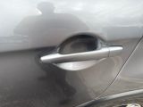 a close up of a car door handle with a person in the background