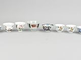 six cups with different designs and designs on them on a gray surface