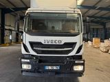 a white truck that is parked inside of a building