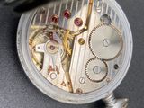 a close up of a pocket watch with a chain