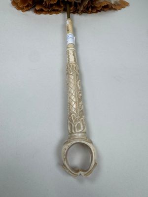 a bottle opener with a flower on top of it