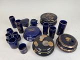 a lot of blue vases and cups sitting on a table