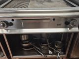 a stove with pots and pans on it in a kitchen