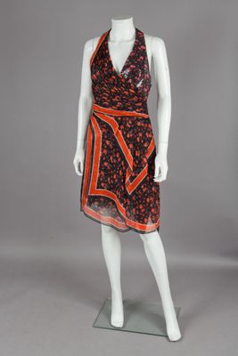 a mannequin wearing a dress with an orange and black print