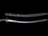 two old swords are shown against a black background