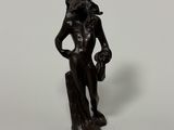 an image of a statue of a woman holding a bag