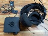 a picture of a pair of headphones and a charger on a table