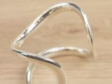 sterling silver wave ring on a wooden surface