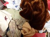 a teddy bear sitting on top of a pile of clothes