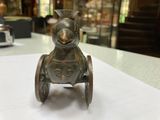 a small metal toy on a table in a room