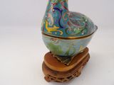 a colorful bird sitting on top of a wooden stand
