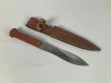 a knife and a sheath on a white surface