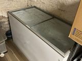 a refrigerator in the corner of a room with a box on top of it