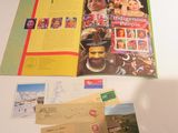 a table that has a bunch of postcards and a book on it