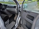 doorway view of a car with the door open and the driver ' s seat down