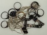 a pile of assorted metal items on a white surface