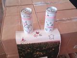 two cans of soda sitting on top of a cardboard box