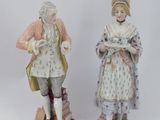 pair of porcelain figurines of a man and a woman