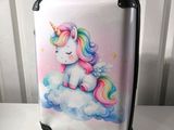 a suitcase with a picture of a unicorn sitting on a cloud