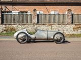 a silver car that is parked on the side of the road