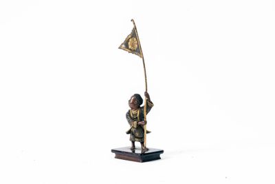 figurine d'un homme tenant un drapeau sur une base en bois