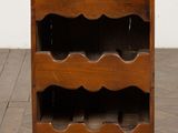 an old wooden wine rack with wine bottles on top of it