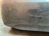 a close up of a car ' s bumper with a dirty paint job on it