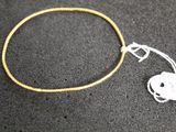 a close up of a bracelet with a tag attached to it
