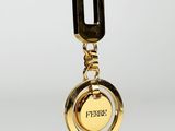 a gold keychain with a lock hanging from it ' s side