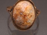 an image of a ring with a stone in it on top of a table