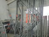 a large room with a lot of metal pipes and ladders