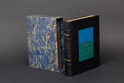an old book with a blue cover sitting on top of a table