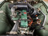 a small engine in the back of a green boat
