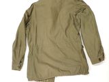 the back of a military jacket on a white background