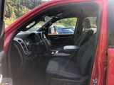 the interior of a red truck with the door open