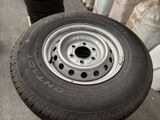 a tire that is sitting on the ground next to other tires