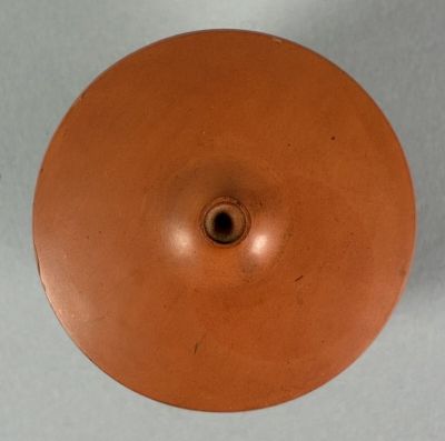 a brown vase that has a hole in the middle of it