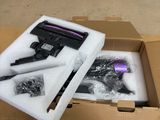 a cardboard box with a gun and other items inside of it