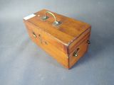 a small wooden box with a handle on a table
