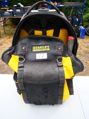 a black and yellow backpack that is on a table