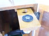 a close up of a door handle on a wooden cabinet