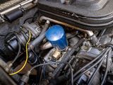a close up view of a car ' s engine with a blue cap