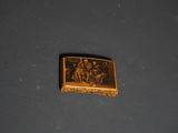 a picture of a gold plate with a picture of a group of people on it