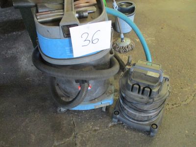 a machine that is sitting on the ground with a hose