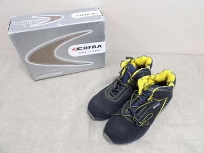 une paire de bottes bleues et jaunes pour enfants à côté d'une boîte à chaussures