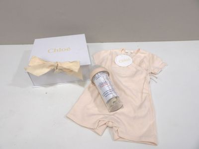 a baby bodysuit and a bottle of water on a table