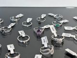 many different types of rings on display on a table