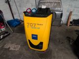 a yellow machine that is sitting in a garage