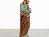 a statue of a man in a brown robe holding a cane